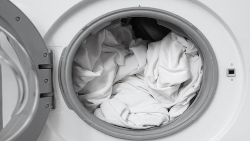 White fitted sheet inside a washing machine